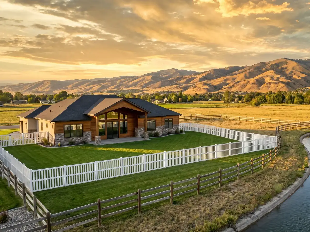 A Star home with a white fence beside an irrigation canal at golden hour