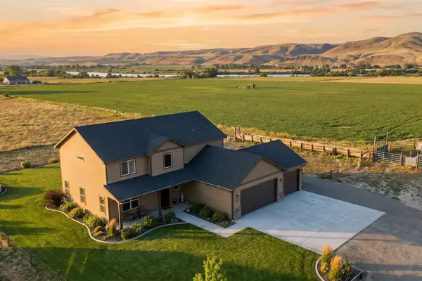 A Kuna home beside irrigated farmland at golden hour