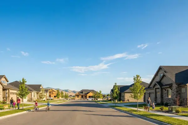 A North Meridian street of newer homes, with the foothills behind